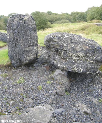 Black slag left behind after resmelting of lead rich waste in the 19th century.